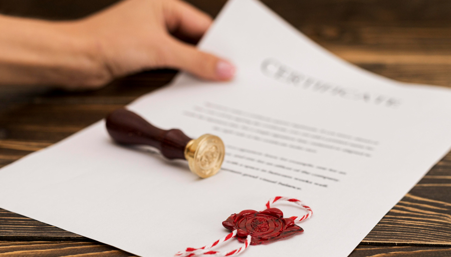 A red wax stamp on paper represents Victoria's Energy Efficiency Certificates (VEECs).