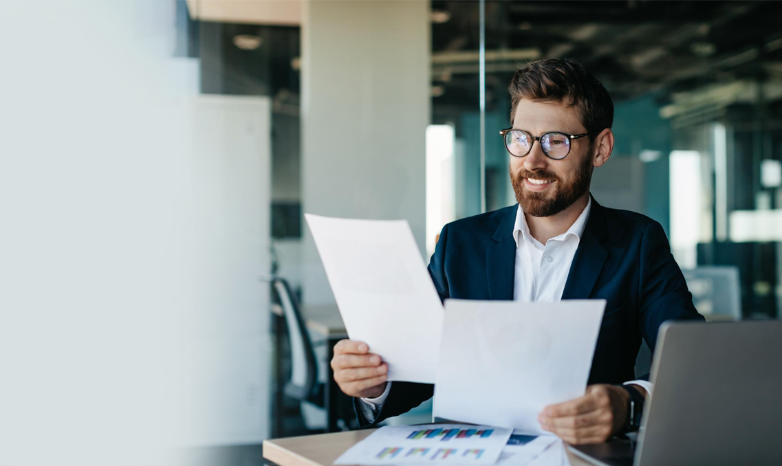 Businessman in suit reviewing paperwork.